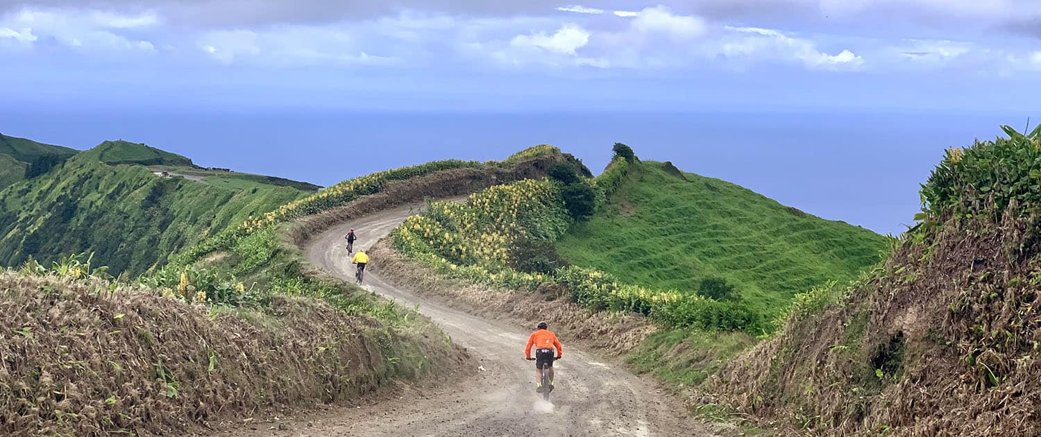 Mountain biker riding volcanic island road in São Miguel Azores