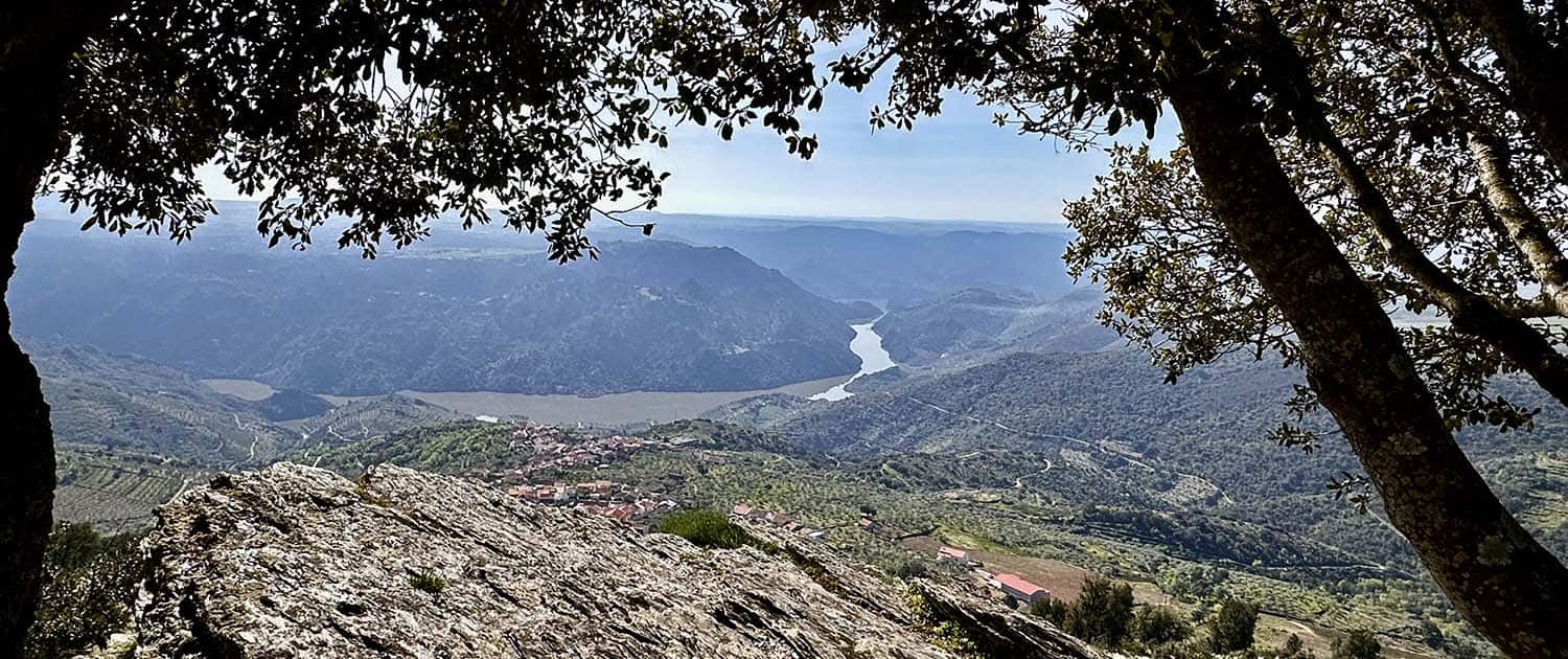 A view of the mountains and hills from a hillside.